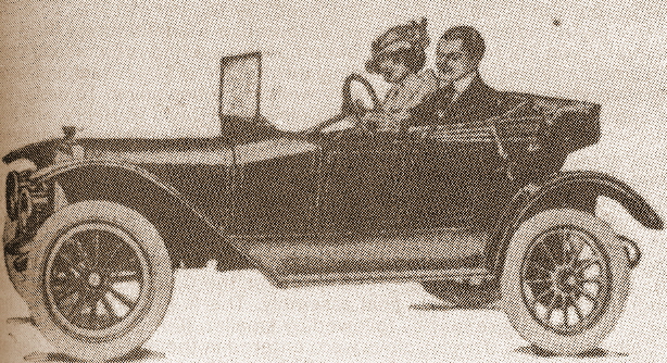 A black and white scanned image of a man and a woman in a Coey Bear motor car